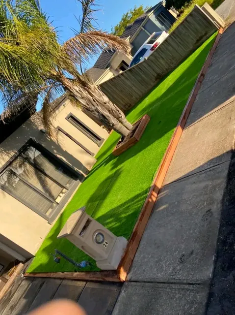Synthetic turf with timber edging