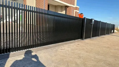 Black slat fence