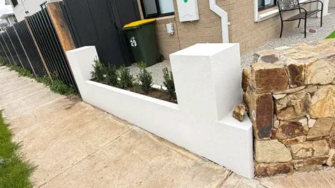 White rendered wall and stone